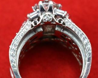 Lot 832 Ring-14K White Gold Band With Center Stone 2.01K- Ladies multi rings  put together, center ring is 18k white gold has a 2.01ct Marquise center diamond I/SI2 GIA cert#1162577946 with 50 side princess shape diamonds @ 2.90cttw G/Si1, 20 round diamonds @ .18cttw G/SI1i quantity of 4 round diamonds @ .13ct each G/SI2 for a total weight of .52cttw.  On each side of the center ring is a 14k white gold 3 stone ring each center is 3/8ct princess shape HI/I2 and 2 princess shaped diamonds @ 3/8cttw HI/I2 with 10 round diamonds @ 1/5cttw HI/I2, for a total for both rings @ 2.00cttw.