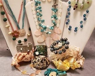 Costume bead and shell necklaces, bead and wire bracelets together with a sample of the seashells we have to offer
