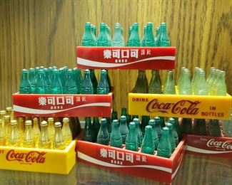 Cases of miniature Coca Cola bottles in plastic crates