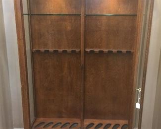 Two lighted custom made gun cabinets.