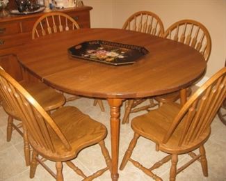 Round kitchen table with 2 leaves. 6 oak chairs sold separately