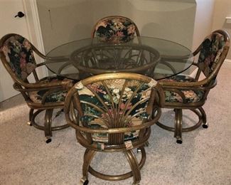 RATTAN GLASS TOP TABLE AND 4 CHAIRS ON CASTORS