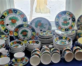 Large set of colorful Mexican pottery dishes.