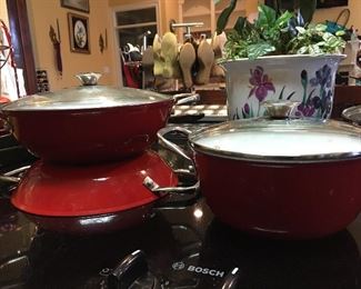 Wolfgang Puck Red Enamel Ware
One Medium Covered Pot 
One Large Covered Pot
One Frying Pan  with Handles & Lid
