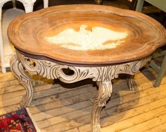 Very ornate, carved wood table with Eagle inset under glass. 