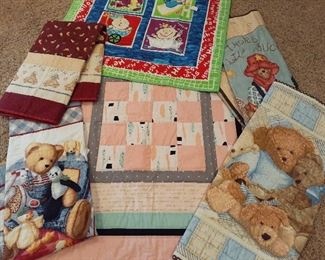 Dozens of hand-crafted quilts, baby motif shown