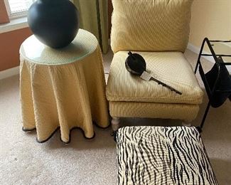 Fashion table, large lamp, upholstered chair with metal casters, cool zebra-print ottoman with tassels
