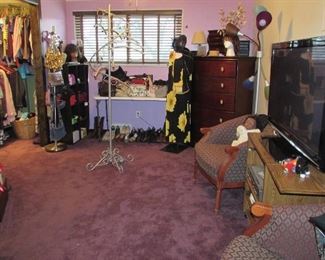 Overview of Bedroom with  Purses, Shoes, Socks, Clothing, Chairs and TV
