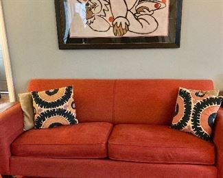 Red/ orange sofa $350..  Measures 81 " by 35 "  by 32 "; "The Clown" is sold