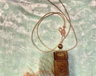 Carved pendant on cord