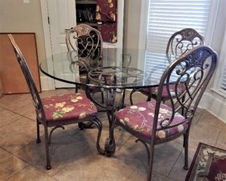 Wrought iron, glass-topped breakfast table with 4 chairs