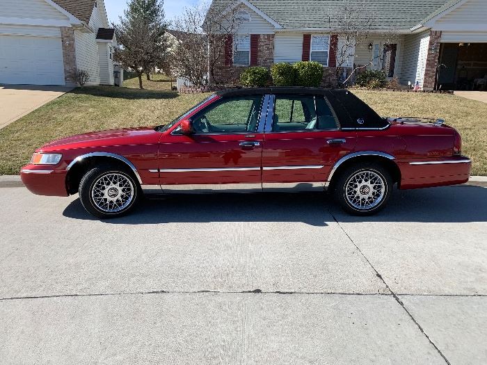 This 2000 Mercury Grand Marquis GS is a real beauty and showroom perfect.  One owner (retired woman) and always garaged.  Black soft top with sunroof, wire wheels with like new Michelin white walls . Low mileage.