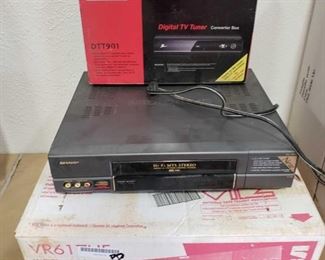 RCA VCR in Box, Sharp VCR, and and NIB Zenith Digital TV Tuner
RCA VCR in Box, Sharp VCR, and and NIB Zenith Digital TV Tuner
