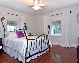 Cast iron bed. Deco nightstands and beautiful Victorian chaise in this room