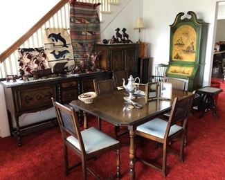 Vintage dining room set, Mexican hangings, MCM desk with bookshelves behind the closed door at the top.