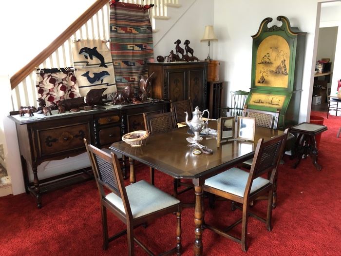 Vintage dining room set, Mexican hangings, MCM desk with bookshelves behind the closed door at the top.