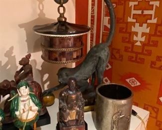 Buddha $80 , metal cannister with repousse figural design $140 Maitland Smith Monkey Lamp $540