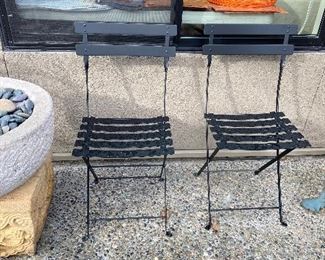 pair of folding black metal outdoor chairs