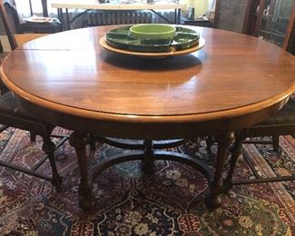 54” round mahogany dining table with 2 leaves (not shown) Some damage to table top. 5 matching chairs too.