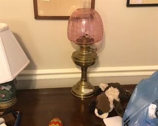 Lovely hurricane lamp. Rose glass globe very unusual.  To get this color gold is added during the manufacturing process.