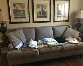 Large sofa with linens.