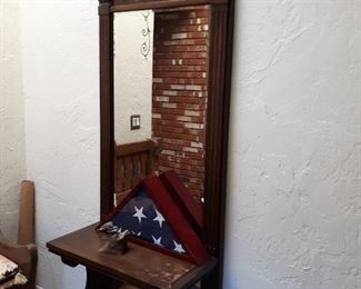 Entry mirror attached to wall with shelf unit