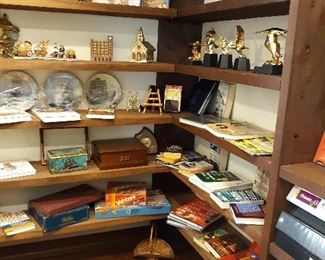 Plates, books, games, statues, and figurines etc on shelves in office