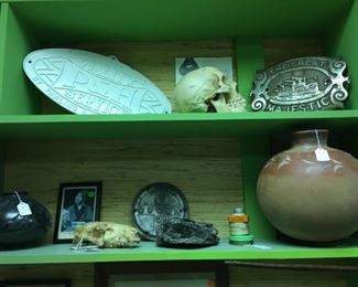 Artifacts, metal advertising plaques, Mexican pottery