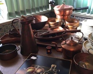 Lots of copper pieces and wood bowls and serving dishes, everyday dish sets
