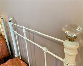 Pair of vintage white washed twin iron beds with crystal knob detail.