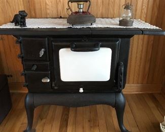 Charming ornate cast stove!  With the little cast-iron puppy on top...