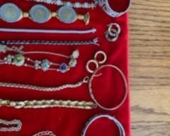 Gold and silver bracelets, earrings, charms, and rings