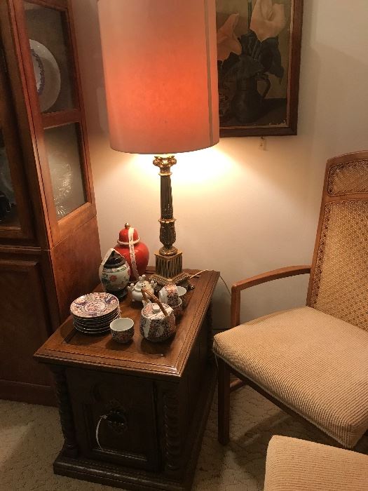 end table with vintage asian decorator pieces and one of a pair of mid century regency lamps 