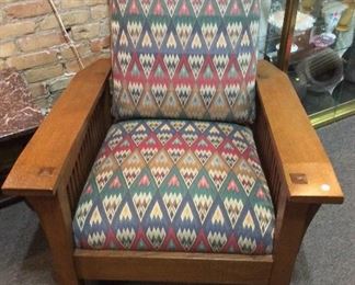 $895.00 Contemporary L. & J.G. Stickley (Manlius, New York) spindle Morris Chair, with four adjustable positions, based on the original Gustav Stickley design. Circa 1980s.  Sun fading to upholstery.