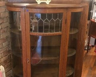 $595.00 Antique curved and leaded glass oak china cabinet with 4 shelves, and top backsplash with beveled mirror - circa 1900