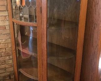 $595.00 Antique curved and leaded glass oak china cabinet with 4 shelves, and top backsplash with beveled mirror - circa 1900