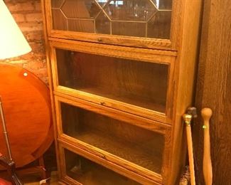 $195.00 One-piece oak barrister style bookcase with 4 doors and beveled and leaded glass work on top door.  36” wide  63” tall  12” deep.  