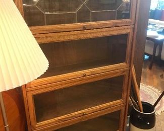 $195.00 One-piece oak barrister style bookcase with 4 doors and beveled and leaded glass work on top door