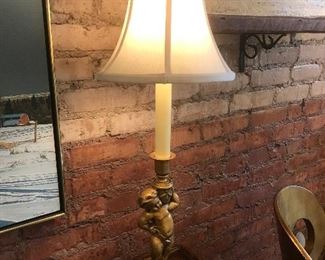 $95.00  Pair of table lamps with bronze colored cherubs holding urns on black bases and paneled bell shaped fabric shaded 