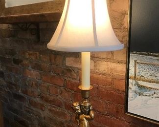 $95.00  Pair of table lamps with bronze colored cherubs holding urns on black bases and paneled bell shaped fabric shaded 