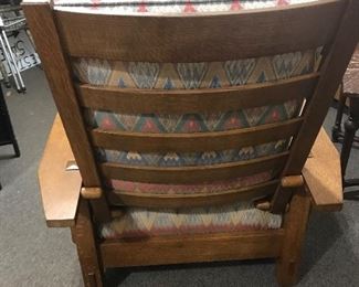 $895.00 Contemporary L. & J.G. Stickley (Manlius, New York) spindle Morris Chair, with four adjustable positions, based on the original Gustav Stickley design. Circa 1980s.  Sun fading to upholstery.
