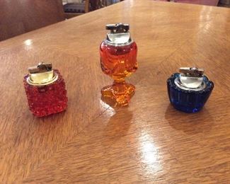 3 Viking Table Lighters. $25.00 Orange hobnail.  $35.00 Tall Orange with base.   $25.00 Short fluted blue.   