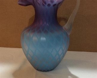 $85.00  Cased glass pitcher 10”  Reeded attached handle in blue and purple.  No marks.  