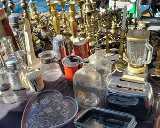 Tables full of brass and copper and glass ware collectibles artifacts antique appliances and more
