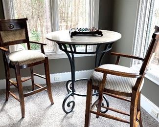 Three piece bistro set: 
40” diameter  stone top with iron base 42” tall by Lorts 