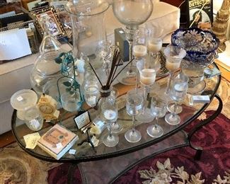 glass coffee tables and loads of candles and candle holders