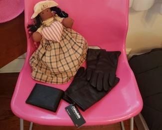 The artist calls this work "Pink chair with doll, wallet and gloves."