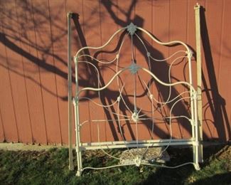 Antique wrought iron bed with side rails.