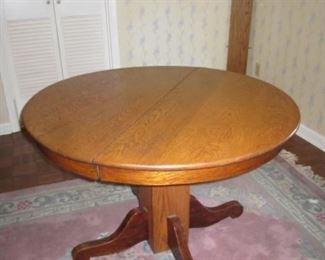 Antique oak dining table with one leaf.