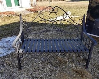 Heavy black wrought iron garden bench.
